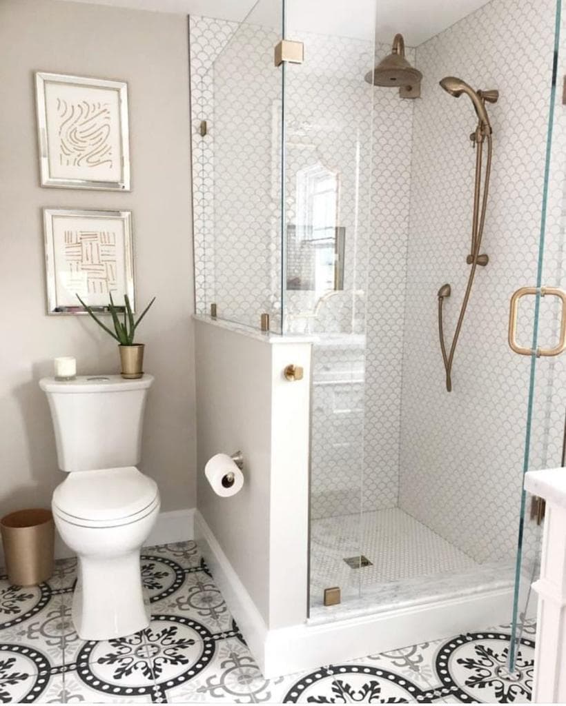 Classic luxury bathroom with brushed gold shower fixtures and scallop tiles